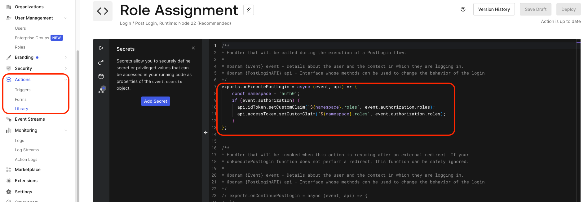 Auth0 Actions code editor showing the Role Assignment action, with the onExecutePostLogin handler setting the auth0.roles custom claim on both the ID token and the access token